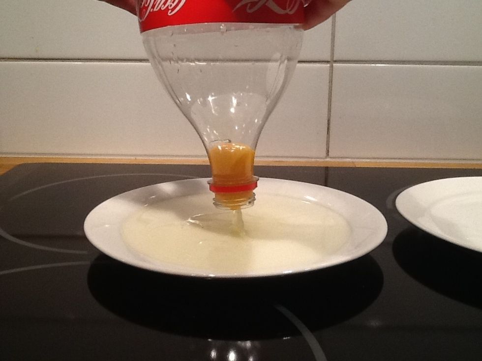 Then you lift the bottle up in the air to the other plate.