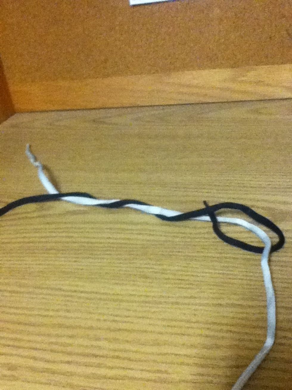 Then you make a loop with the black line by feeding it between the wrap of itself and the white line.