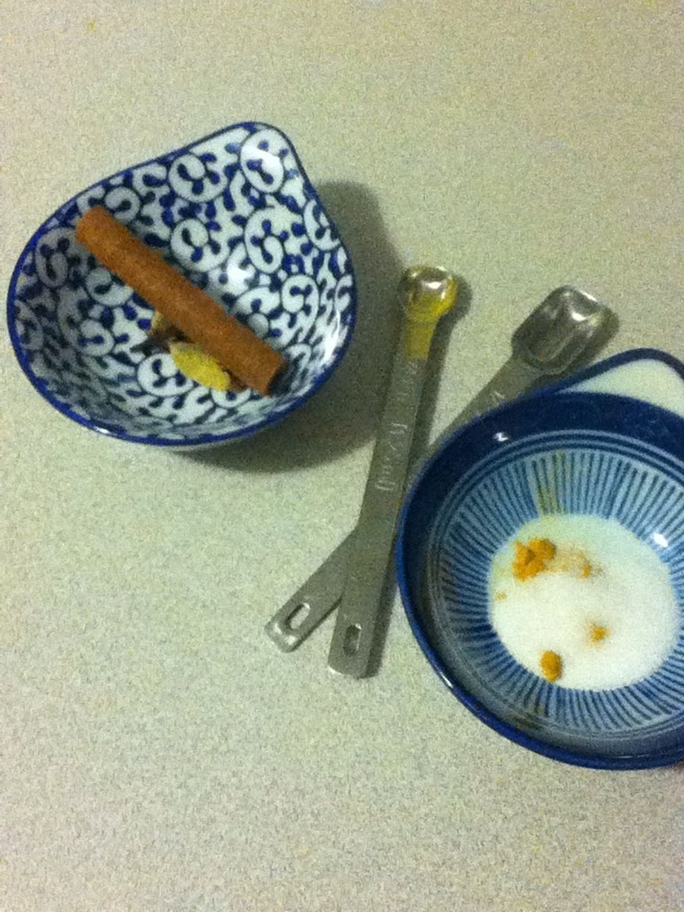 Then you need a cinnamon stick, four or five whole cloves, and two cardamom pods, smashed open.