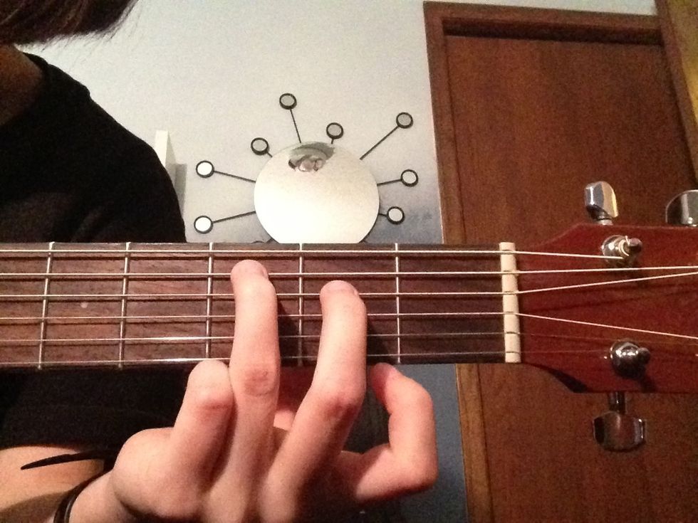 Then you place your middle finger on the second fret of the D string. Be careful. This chord stretches your fingers a bit if you aren't used to it.