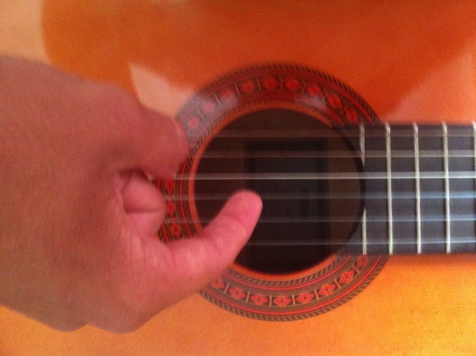 Then you pluck the 3'rd string from the bottom (While holding down 5th thread)