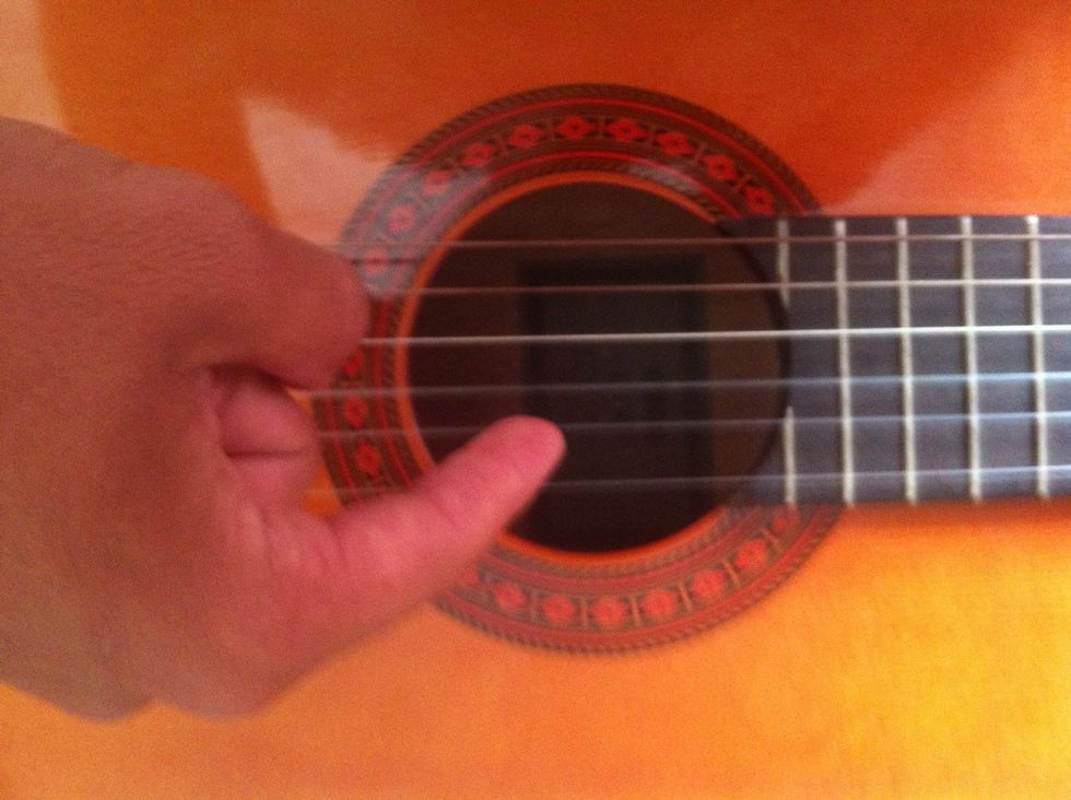 Then you pluck the second string from the bottom (While holding down 5th thread)