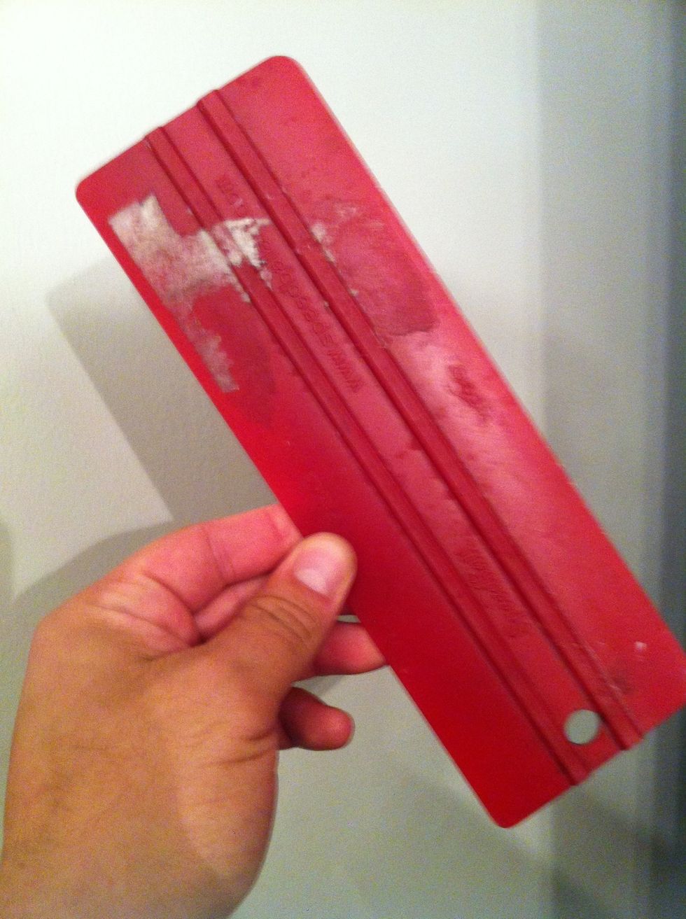 Then you pull the paint across the screen with squeegee like this one.