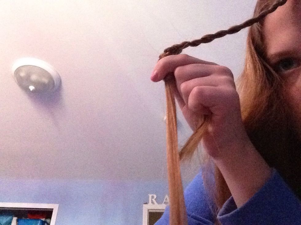 Then you push the two strands up ward holding the center strand down