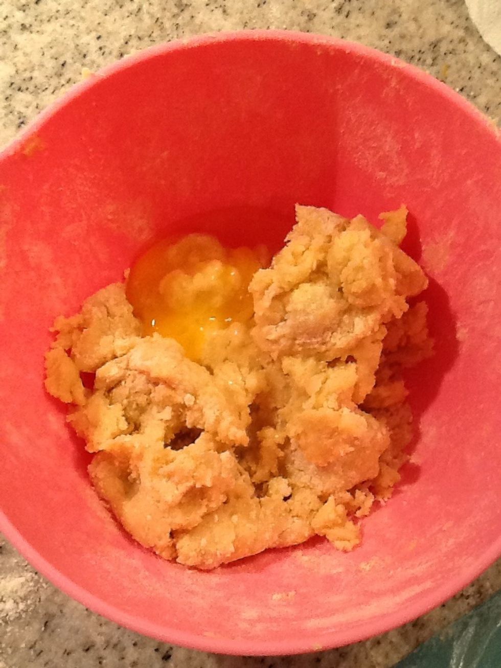 Then you put a egg in the dough and mix.
