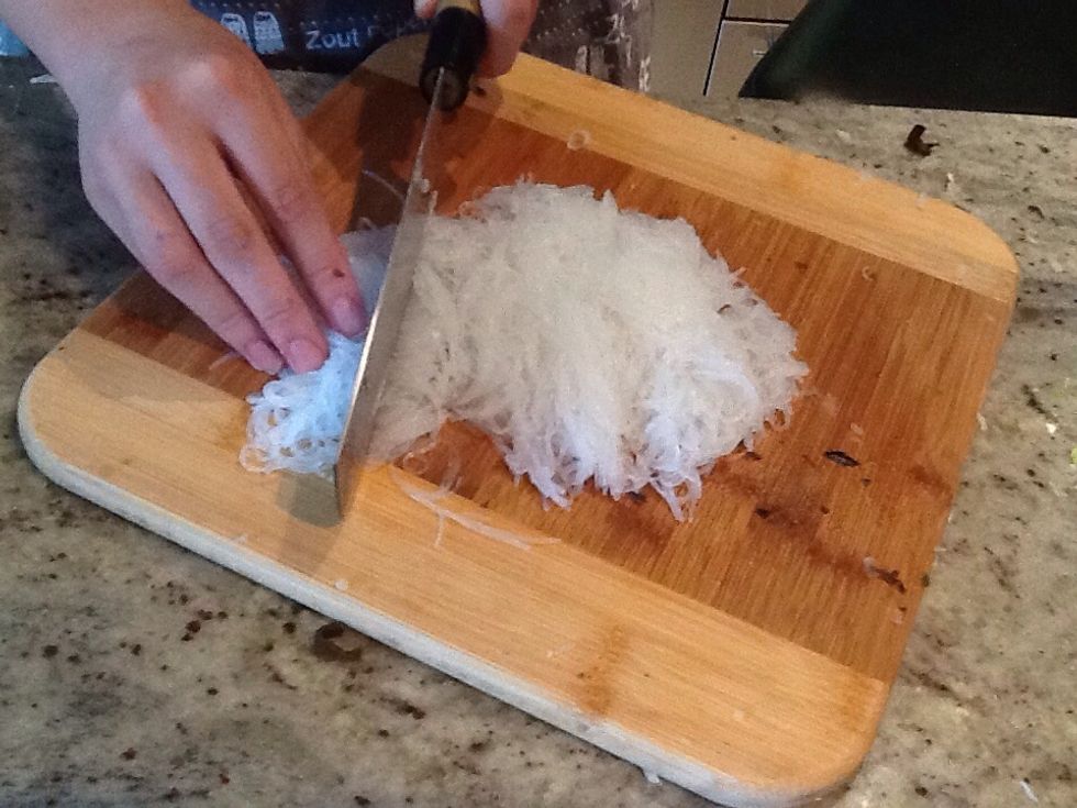 Then you put the vermicelli in hot water for about 10mins to make it soft,then you cut it up into little bits like this