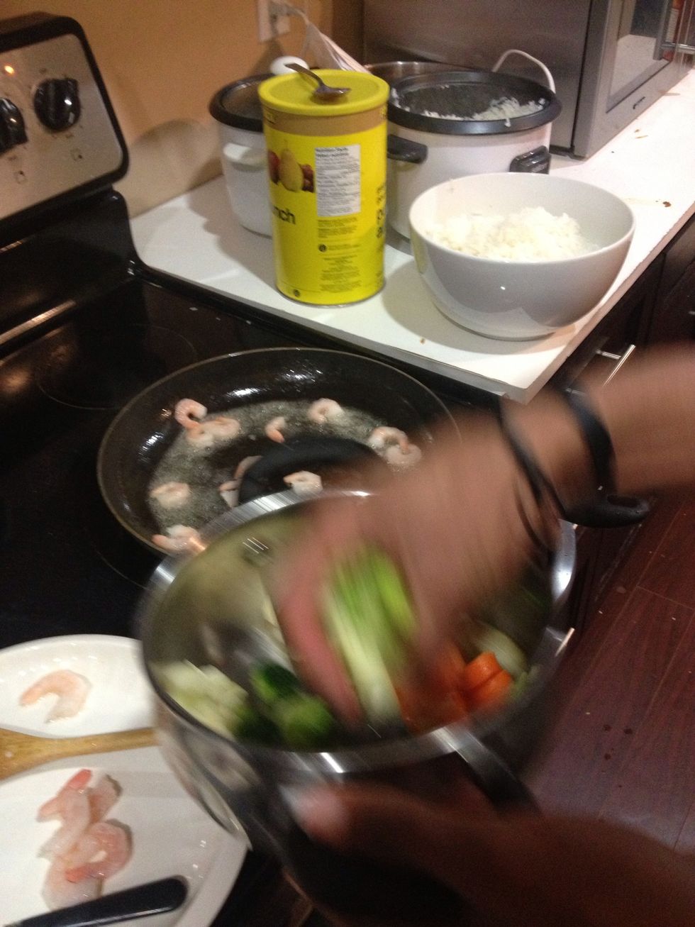 Then you're gonna throw the shrimp in a frying Pan of hot oil & also the veggies