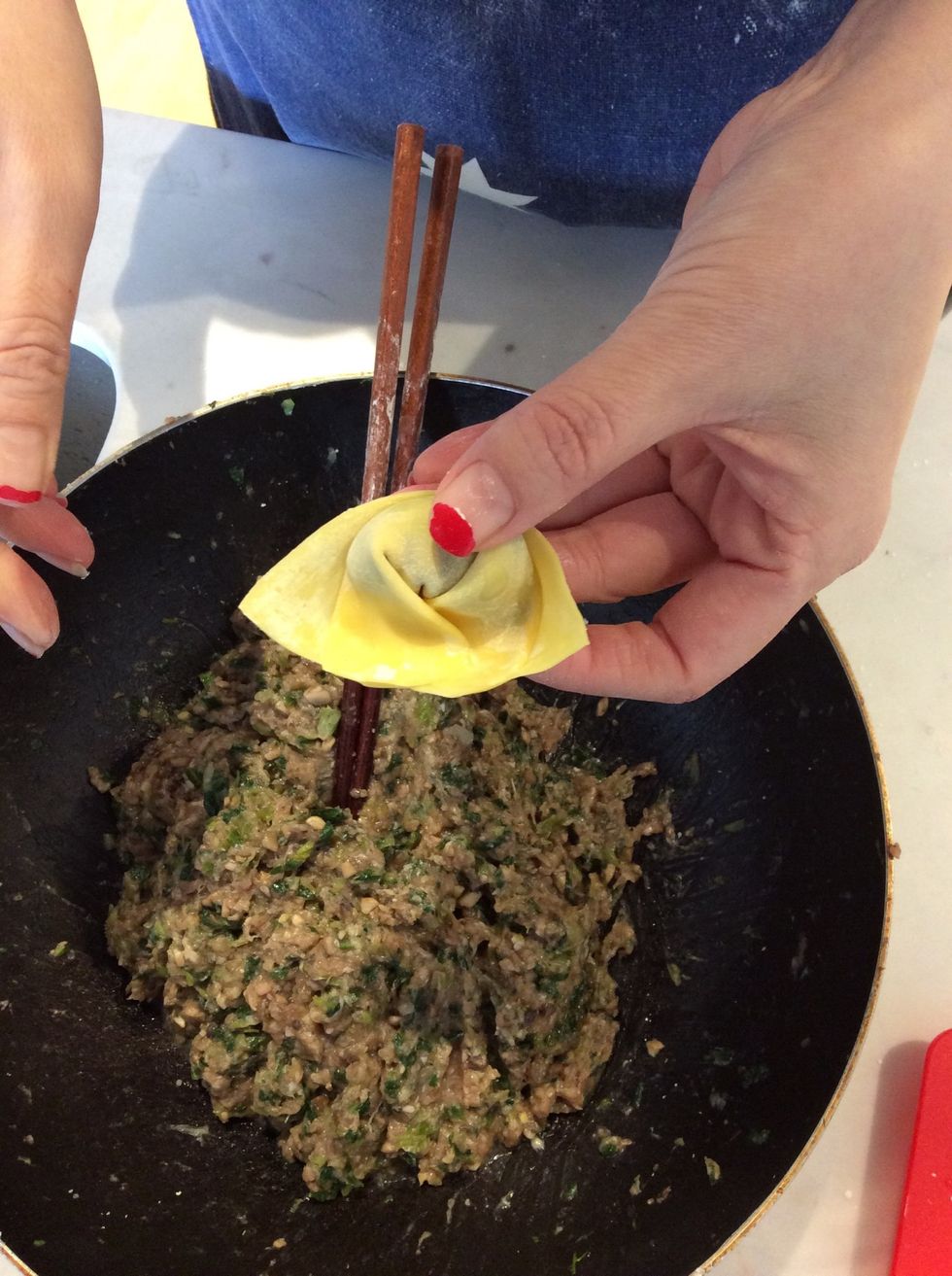 Then you squeeze the two side of the dumpling together