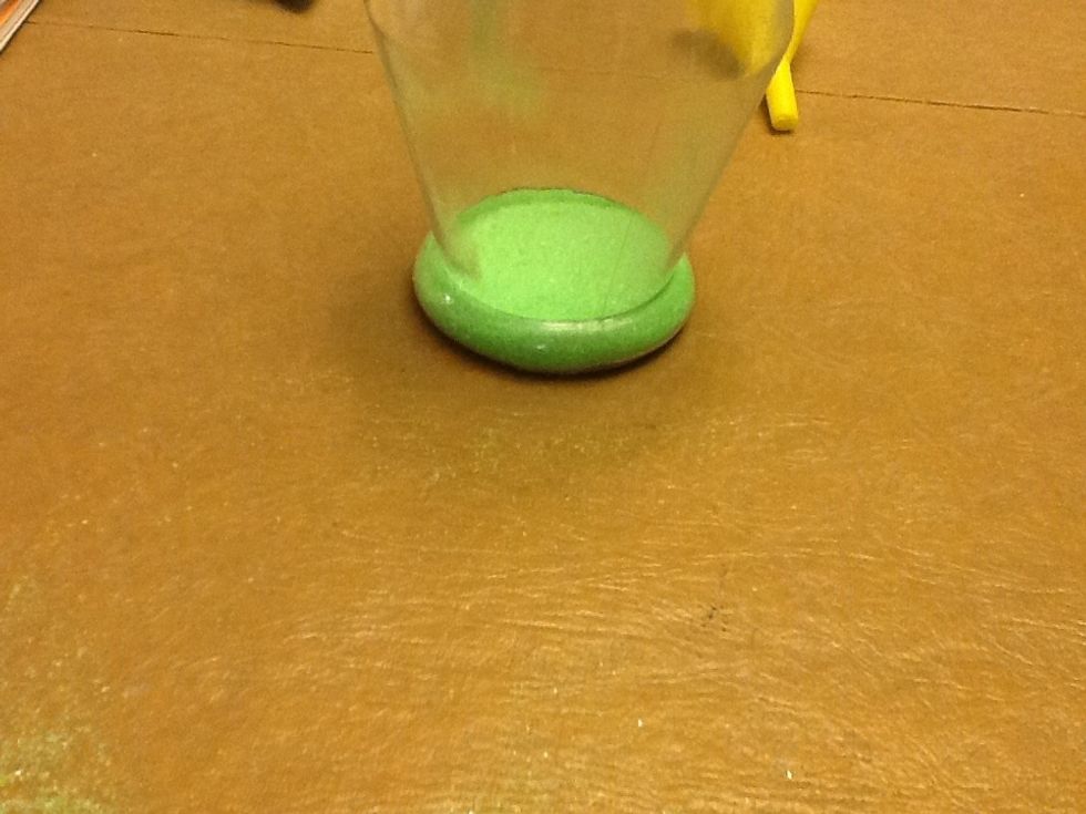 Then you take your first color you want and pour some of the sand in the vase.