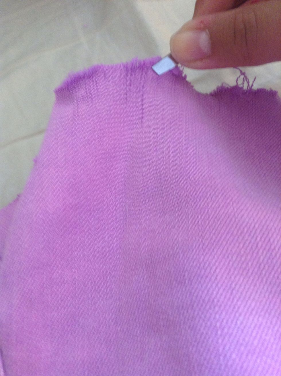 Then you take your tweezers and pinch the very end of your shorts