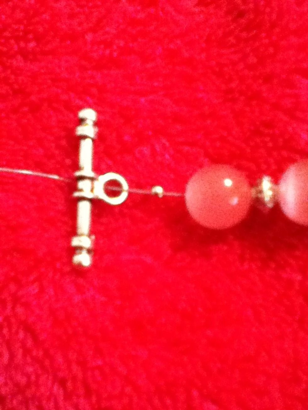 Then you wanna put on the crimp bead and one clasp.