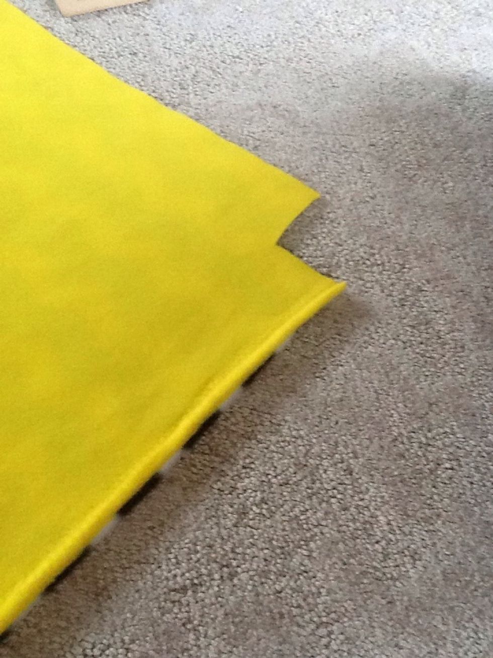 Then, you want to cut 3 by 3 inch squares out of all the corners of your blanket.