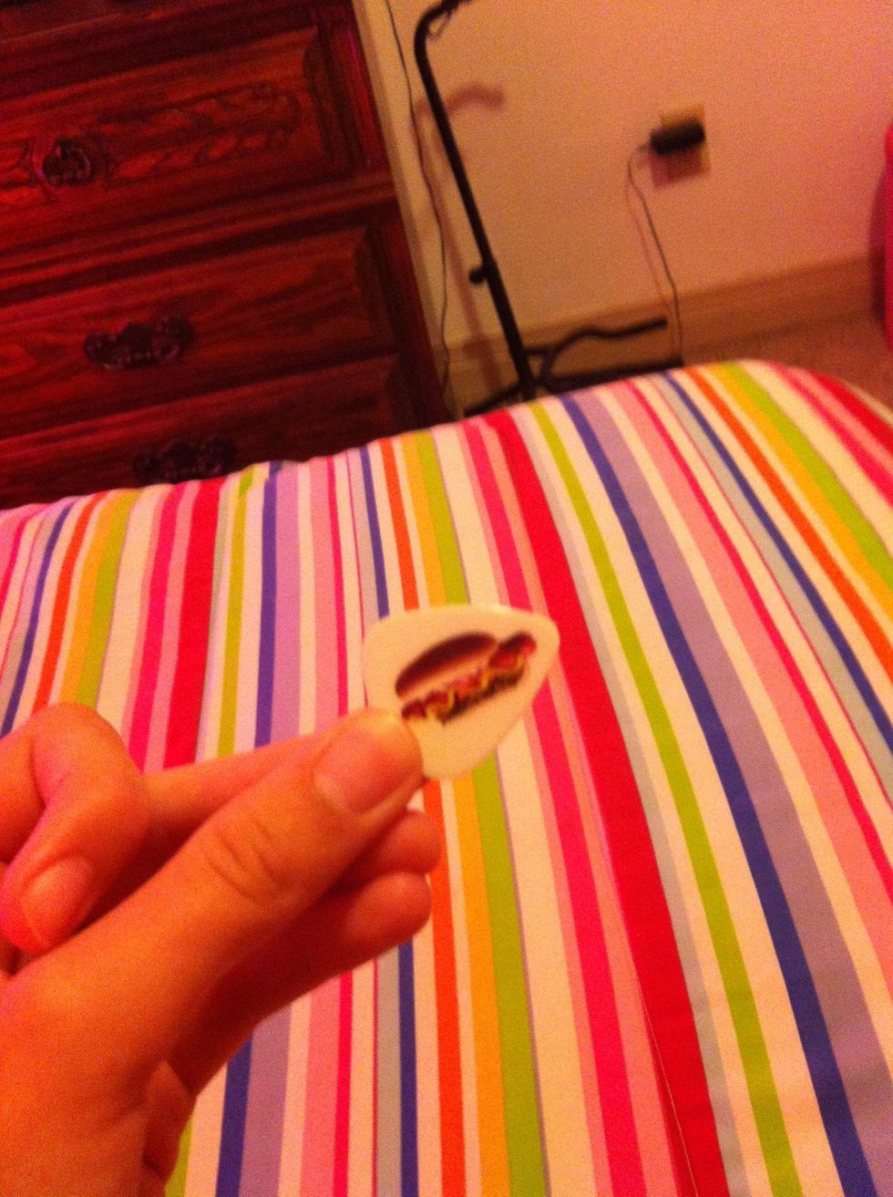 Then you want to take your pick and strum all strings of the guitar.