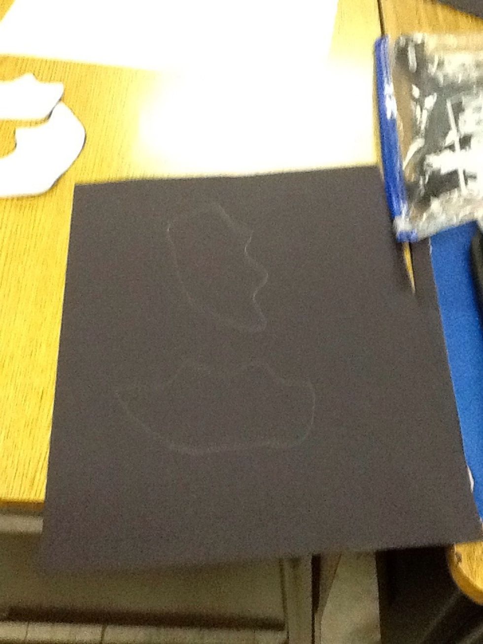 Then you will trace the wings that you cut out of the bat template on a piece of black construction paper.