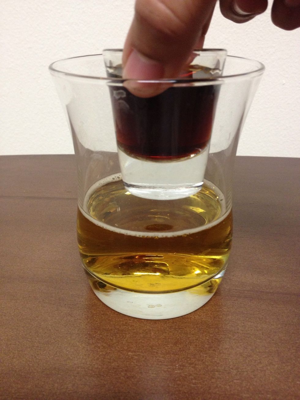 There are different ways to do this part. I like to slowly lower the shot glass. Others like to drop (the bomb) into the glass.