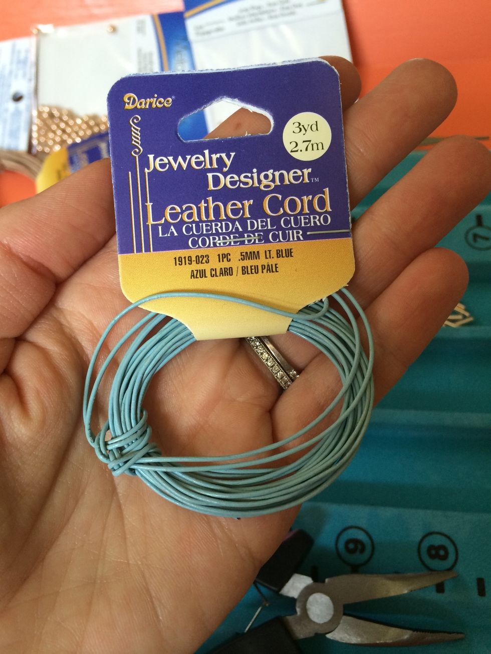 There are lots of different colors in this thin leather cord. You should be able to find it at any craft store.