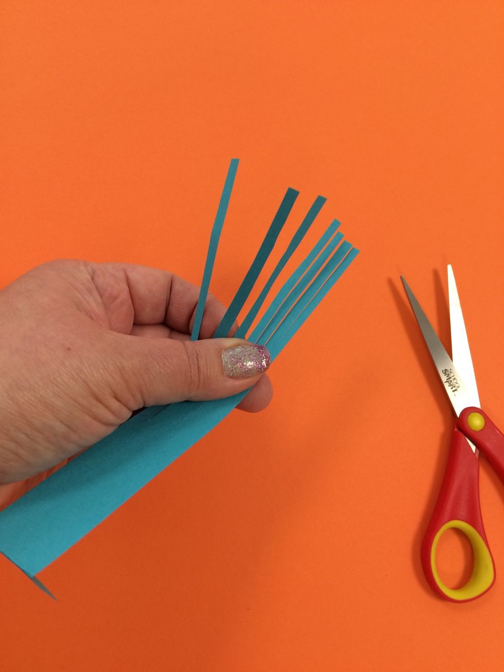 There are many ways to alter the card stock strips. Have fun experimenting! Here is a strip with long fringe.