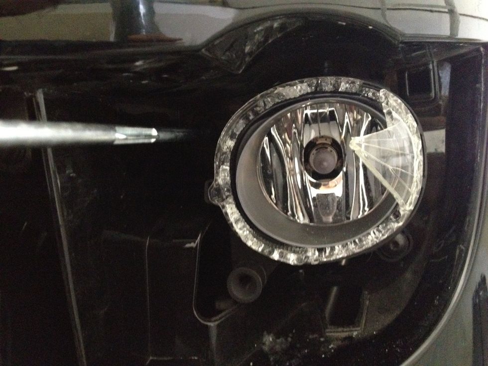 There are two Torx screws we need to remove. One is on the upper-left part (where my screwdriver is at in the picture) and the other is on the bottom right.