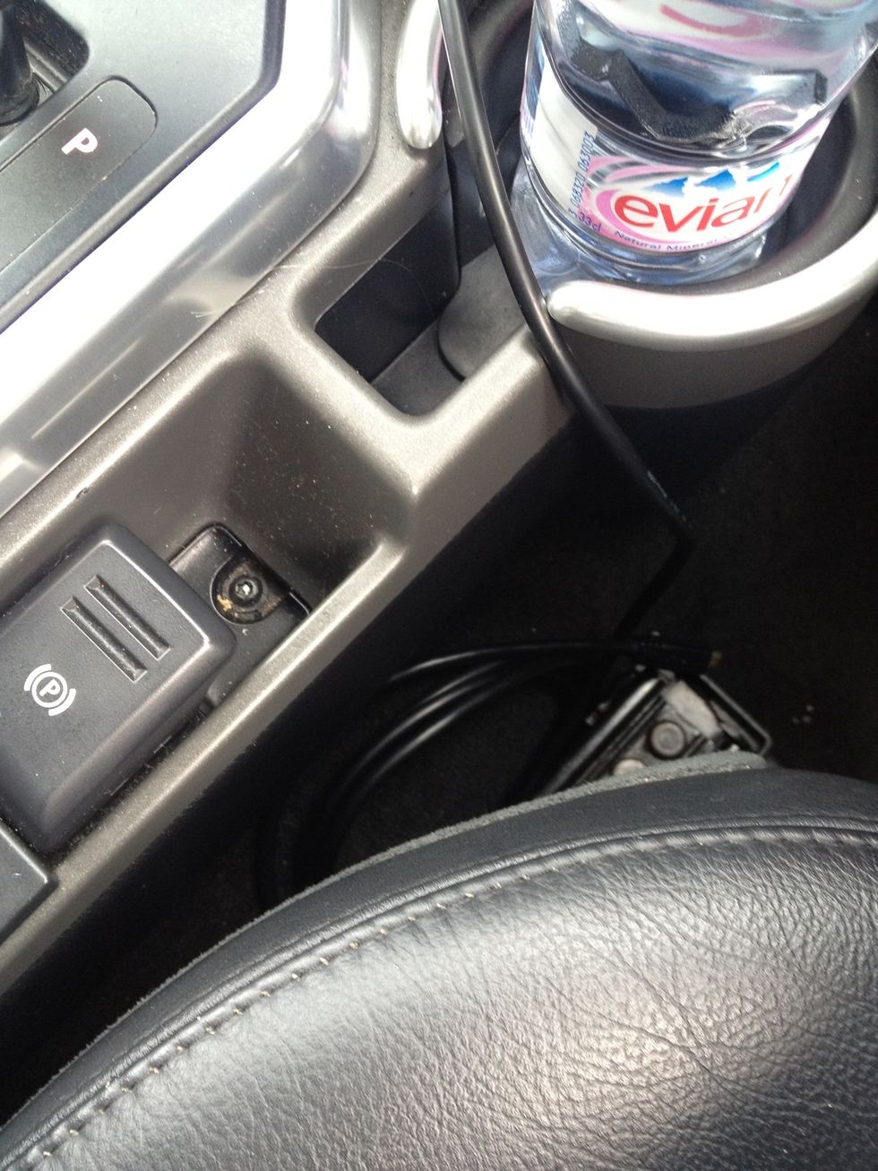 There is a micro usb charging cable (for your phone) and 3.5mm Walkman plug down beside your seat. To listen to an iPod select AUX on the radio.