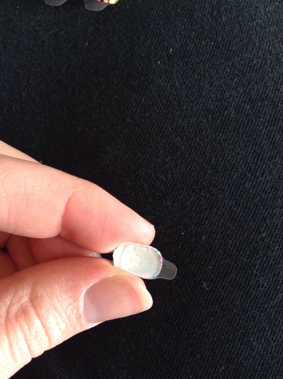 There is a plastic flap on the back of the nail.