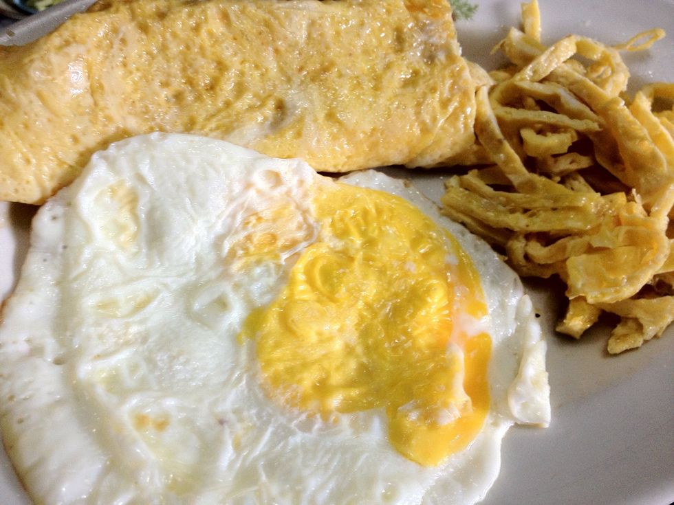 There is no ground rule for the egg but we mostly prepare the egg by frying it though the final result may vary; omelette, curly fried egg or just a simple and humble fried egg