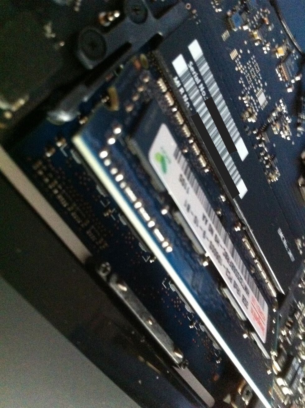 There should be 2 spring-like metal hold your ram, push them to the sides (away from each other). The ram should "pop" upwards. After removing the top ram, the same for the bottom.