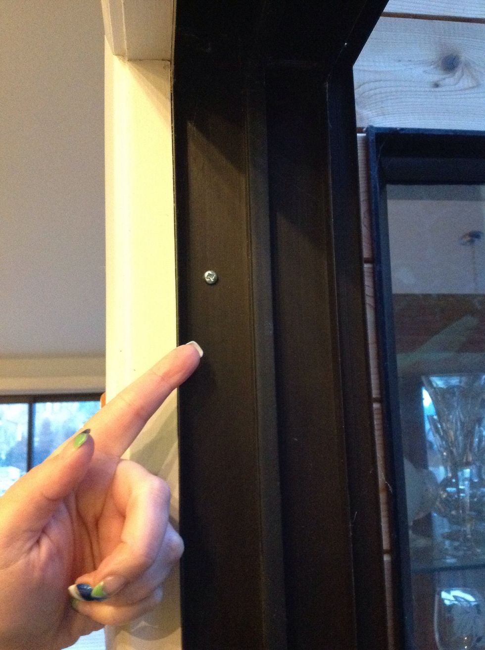 There should be a screw installed high up in the frame of your door.