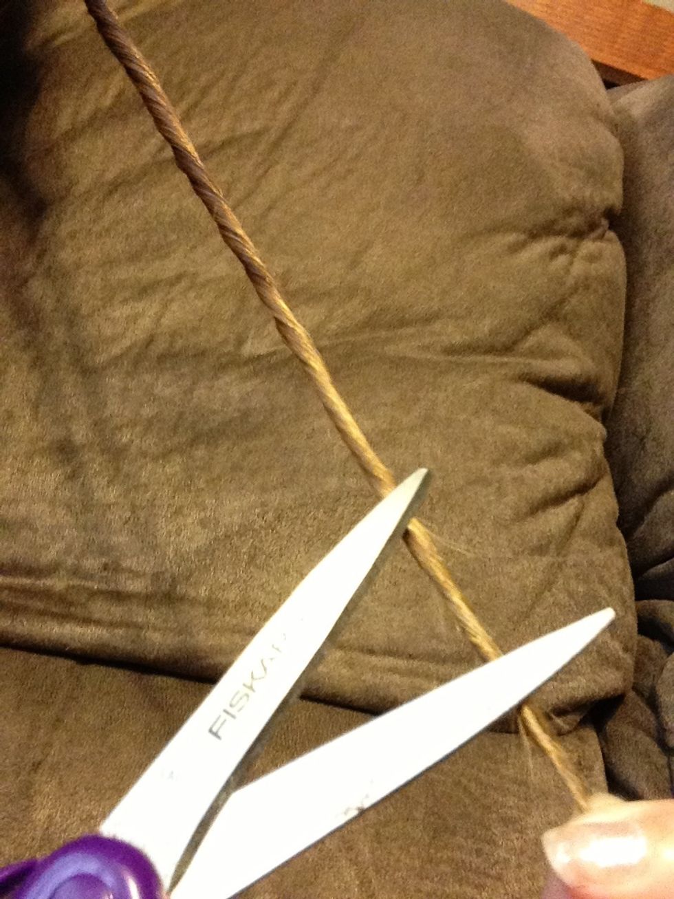 There will be loose strands outside of the twist. (You can't see it in the picture, but if you truly have split ends, you'll be able to see them) take the strands in between the scissors and cut them.