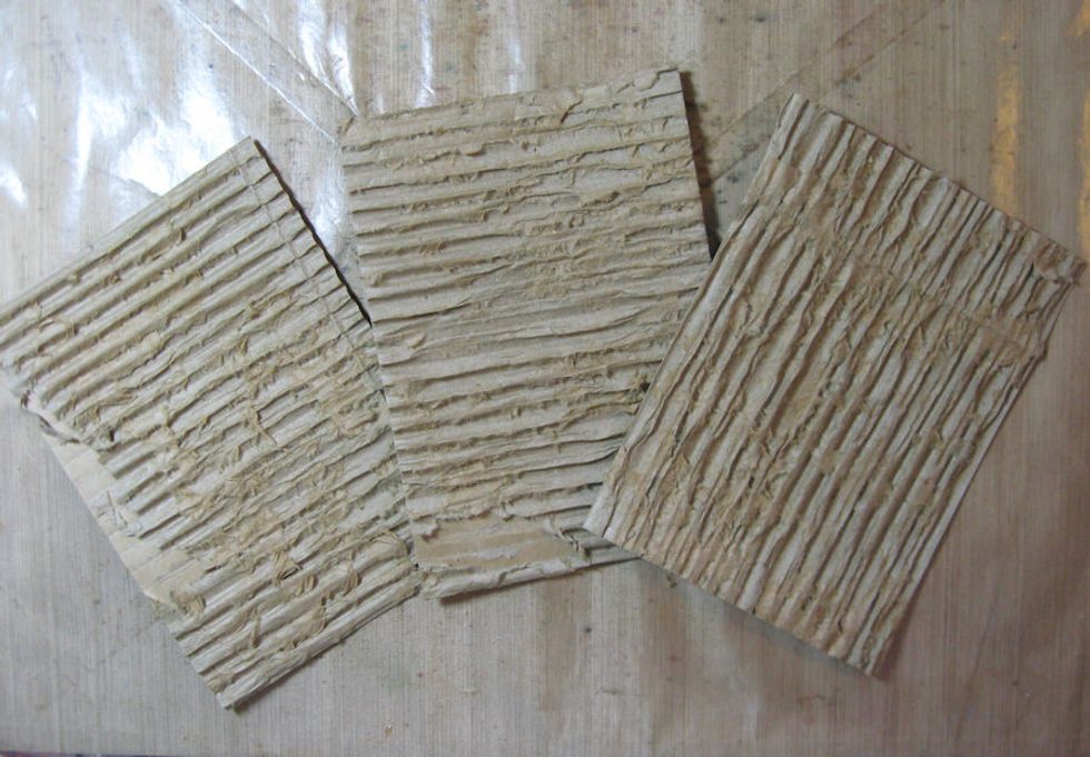 These 5x7 panels were saved from a shipping box.  Strip the top layer of paper to reveal the corrugate.  We will glue these together to create a dimensional canvas.