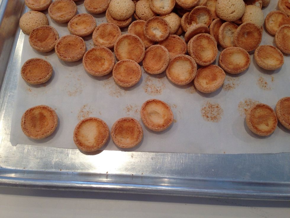 These are almond macaroons which need to be filled with ganache. Aren't you glad you have pastry bags? Put a dollop of ganache on one cookie, then sandwich with another . Think Oreos.