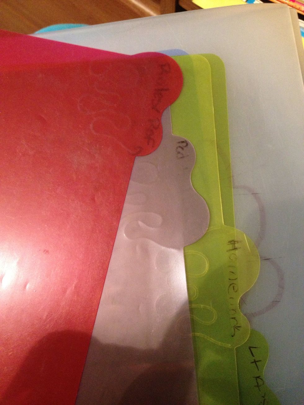 These are just cheap plastic dividers from school several years ago. I'm not sure if its pen or sharpie but either one would come off.