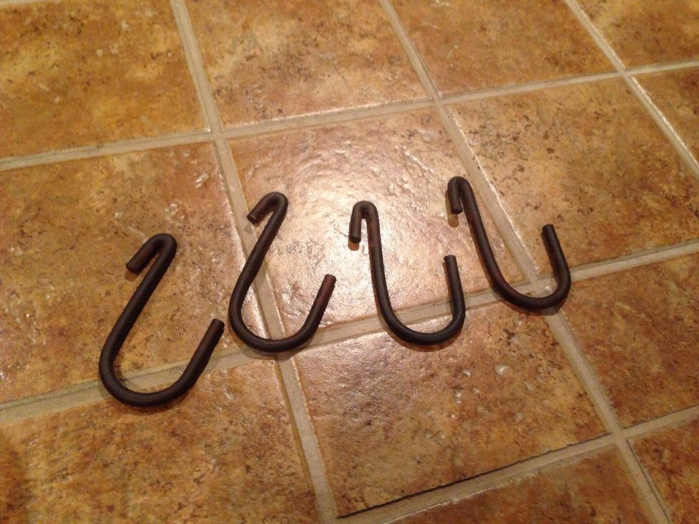 These are pot rack hooks.  However, black "s" hooks will work fine and are at your hardware or home store.  If you can't find black, spray paint them.