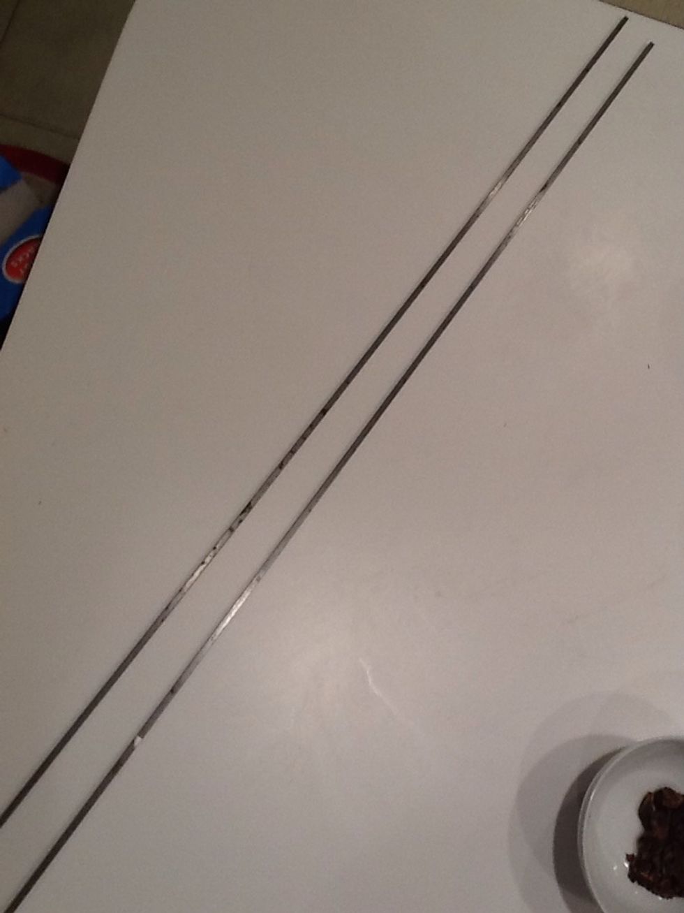 These are steel bar stock. They are flat and less than 1/4 in square. Probably some number of millimeters. Ask the guy at Home Depot. They will enable you to roll the dough evenly. You 'll see.