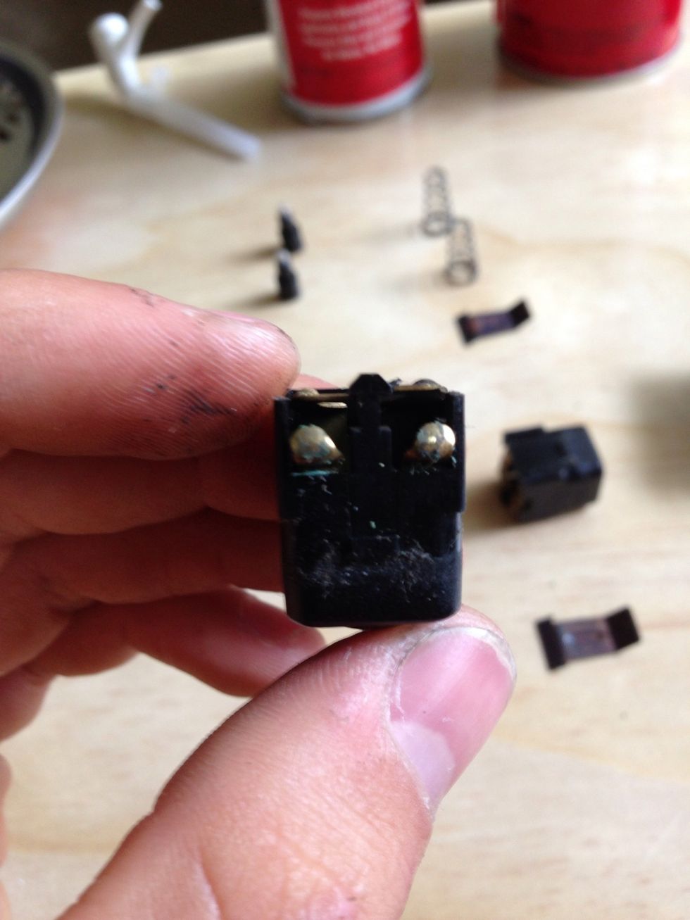 These are the contacts on the button that engage the switch to roll the windows down or up. Sand these lightly and put a dab of dialectric grease on there