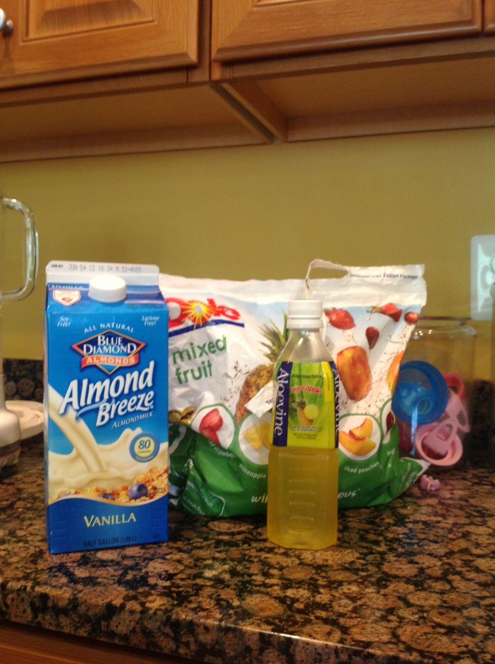 These are the supplies: Dole frozen fruit, almond milk and some aloe juice.