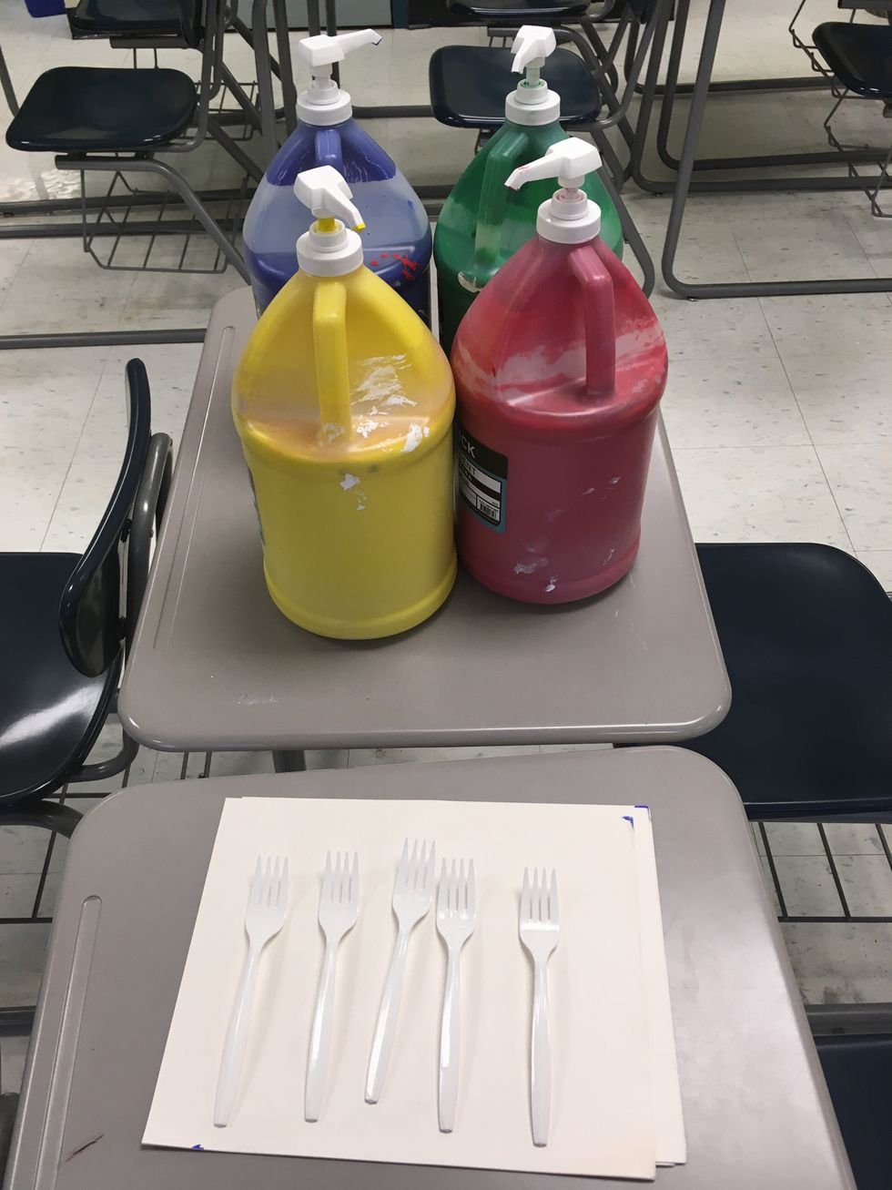 These are the supplies you need. Five forks, any color paint you want, and regular white paper.