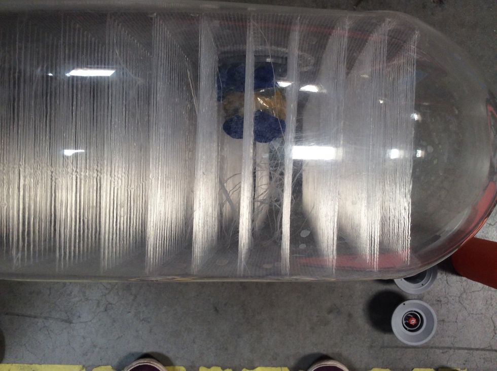 These are the thousands of drop stitches inside your board. See the female valve sitting inside.  It is likely held in place with the male part.  They are tightened together like a bolt and screw.