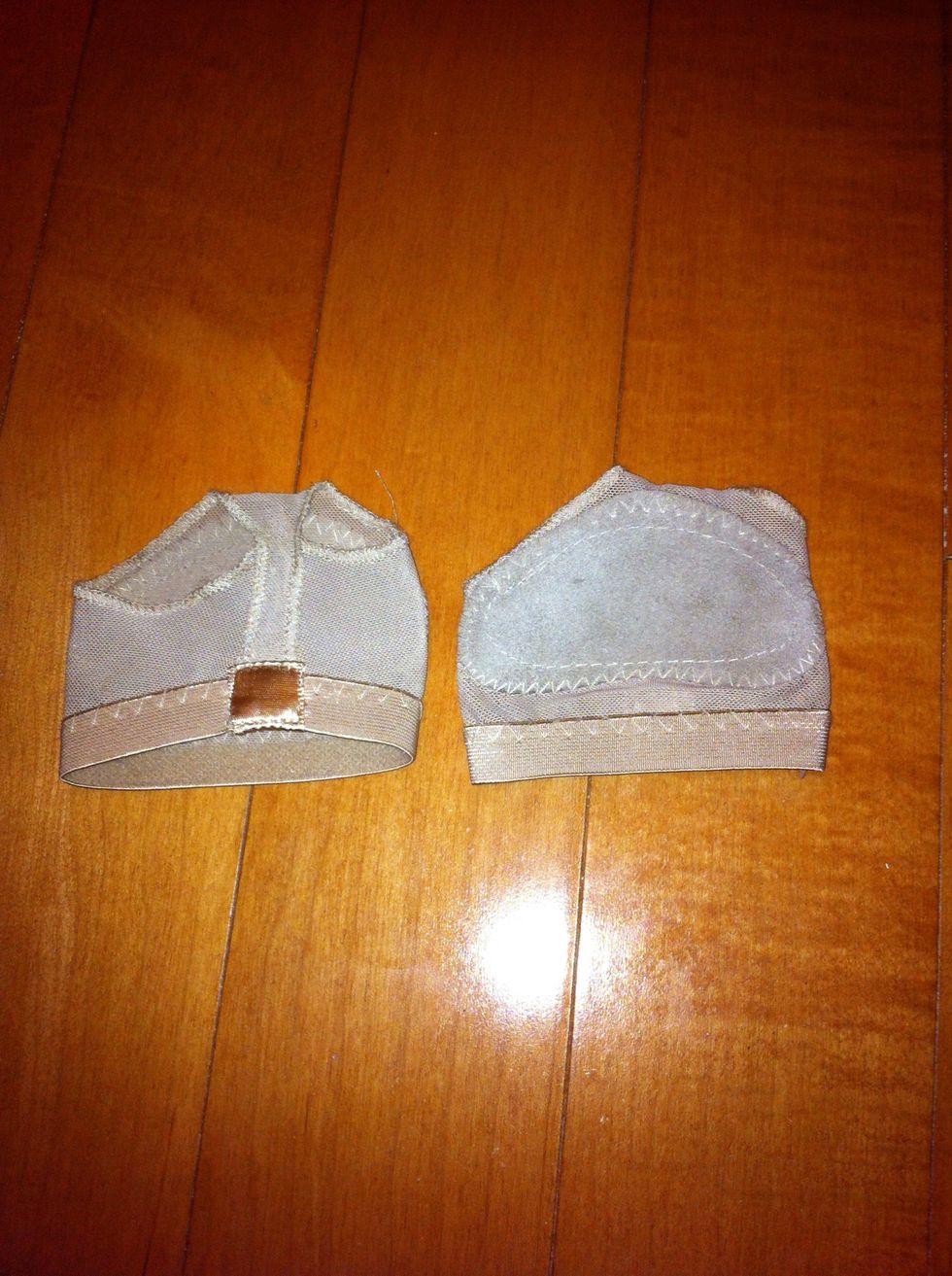 These are Toe-Kinis (: that make it easier to grip your feet when stretching and doing the stunt. You can get them at dance stores, but I got mine at Kmart for $10.