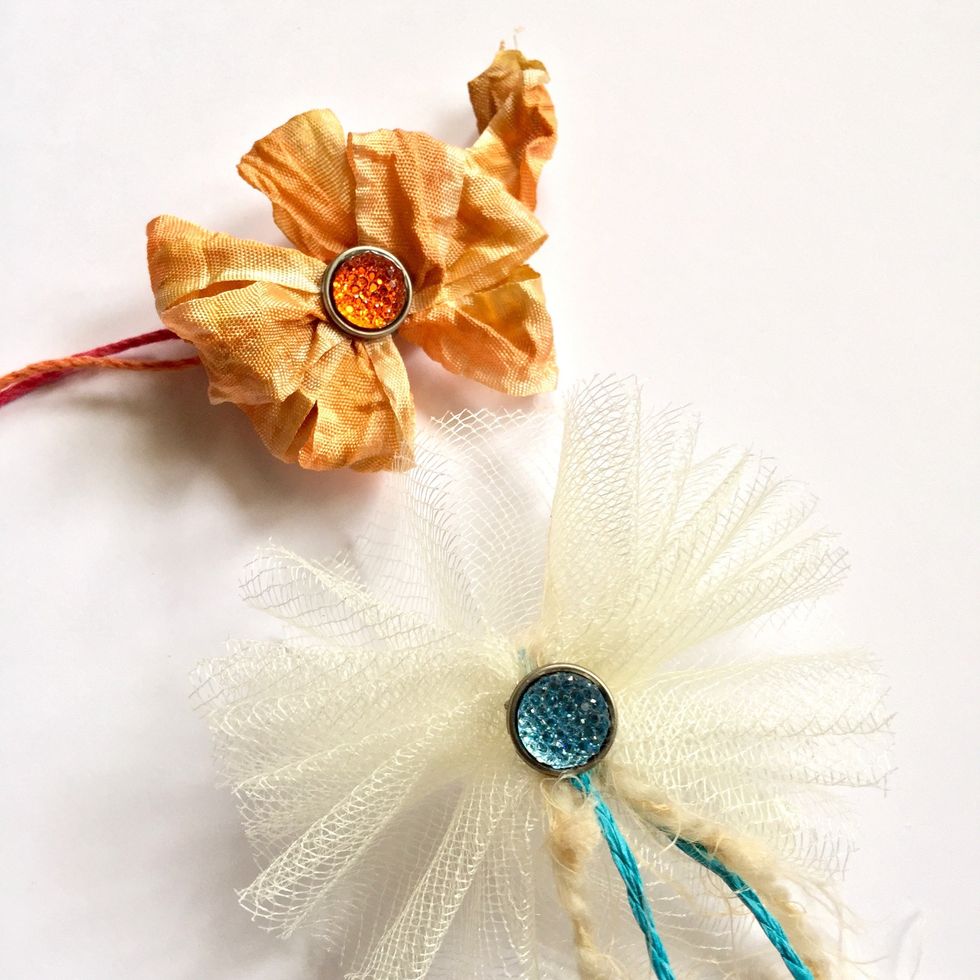 These are two embellishments with ribbons and brilliant brads.