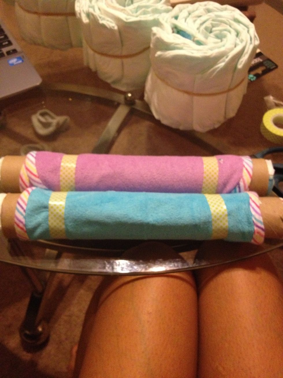 These are two paper towel rolls. I wrapped a washcloth around each one and used the decorating tape to secure them. Also, be sure to roll up a diaper and put them inside each end.