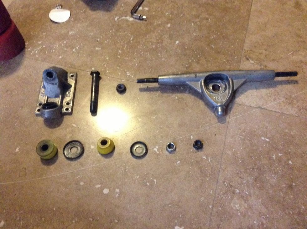 These are your truck parts from left to right: Baseplate, Kingpin, Kingpin nut, Hanger, (second row) Barrel bushing, Large washer, Cone Bushing, small washer, Axle nuts.