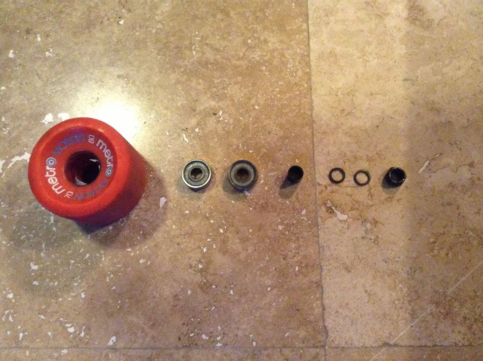These are your wheel components from left to right: Wheel, two bearings, a bearing spacer (optional), two speed rings (small washers), and an axle nut. You should have four sets of these components.