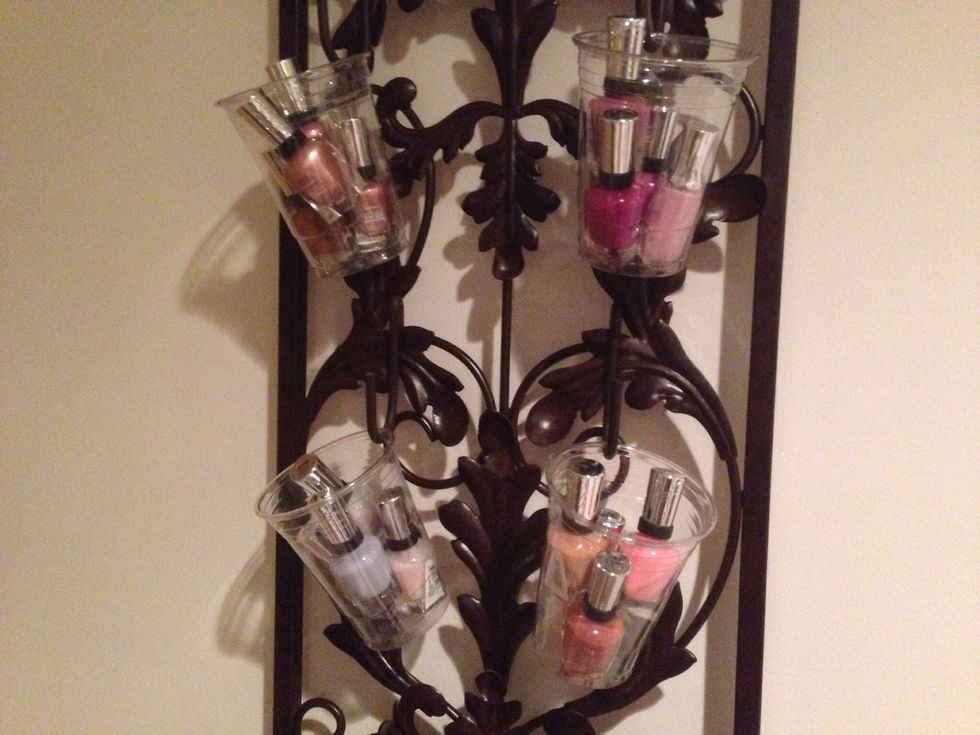 These cups are holding 4 polishes each.  These are Sally Hansen, and OPI bottles would match to this size.  Other brands use even smaller bottles, so more will fit in each cup.