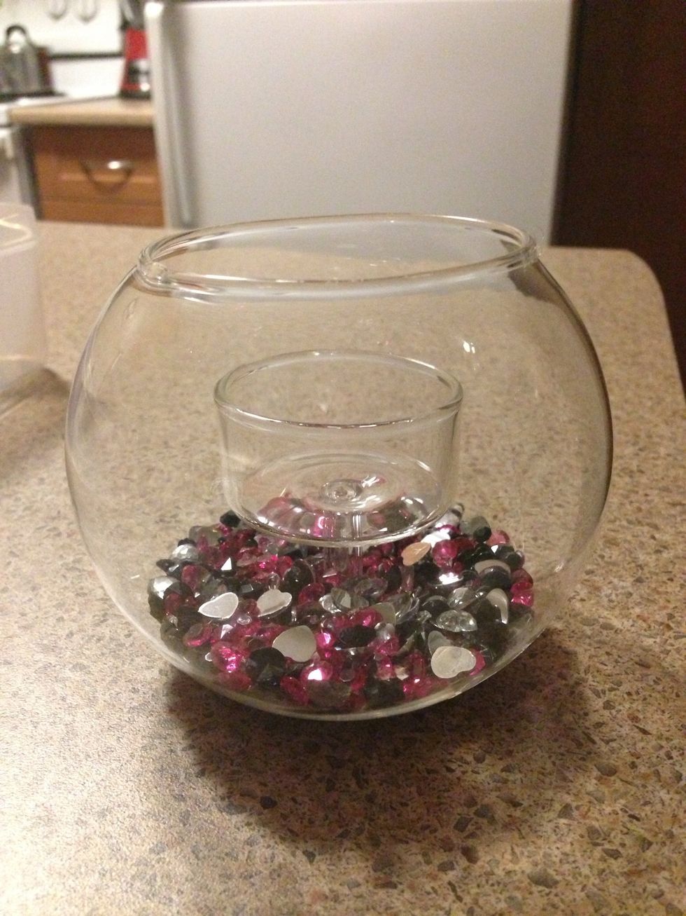These glass votive jars can be found at the dollar store and I bought all the gems inside from eBay for dirt cheap. Place gems of every colour inside your container - just enough to cover the bottom.