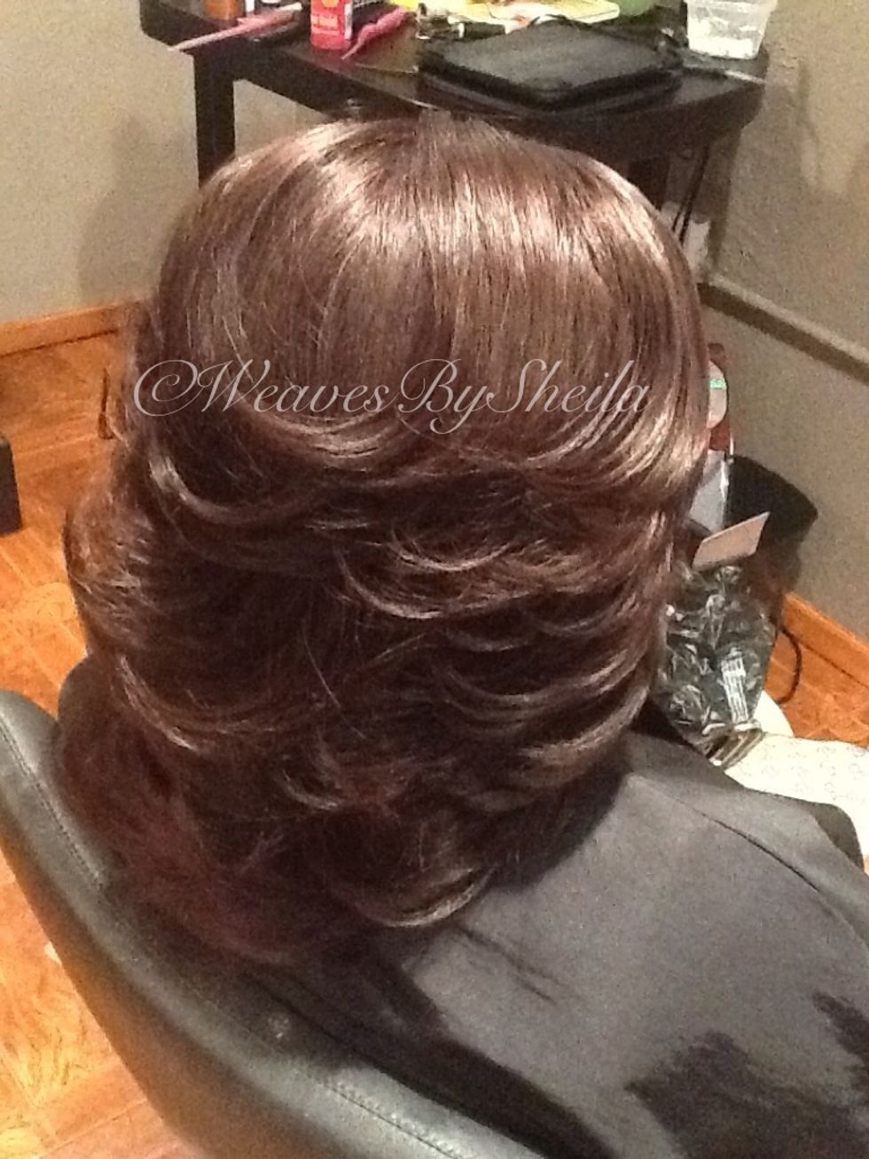 These may be a bit tricky, but all hair was pulled forward with a traveling guide as I stood in front of her to create this 80's feathered look on a sew-in weave.