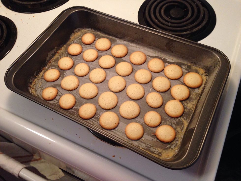 They are ready when the edges start to turn slightly golden. My stupid old stove likes to burn stuff in different spots :| now scrape them off and let them cool down :)