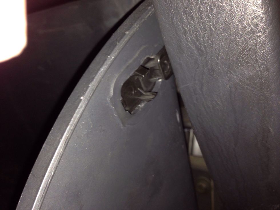 They unlock from the outside of the box. Push them in.