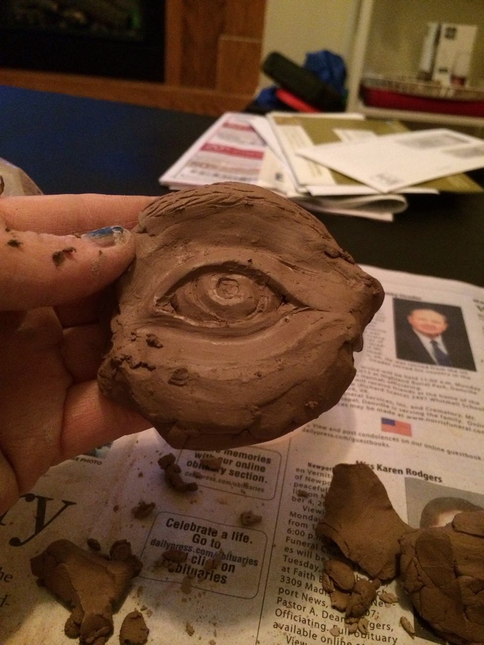 Think about how you would like to show the the iris and pupil. This can be drawn or sculpted into the clay. Normally this detail would be highlighted by several value changes which can't be shown here