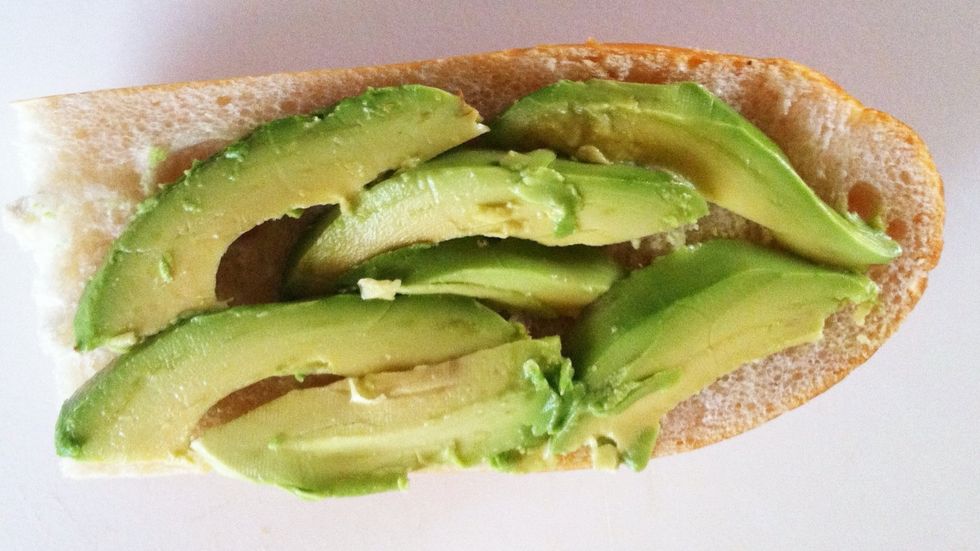 Thinly slice avocado and arrange on bread.