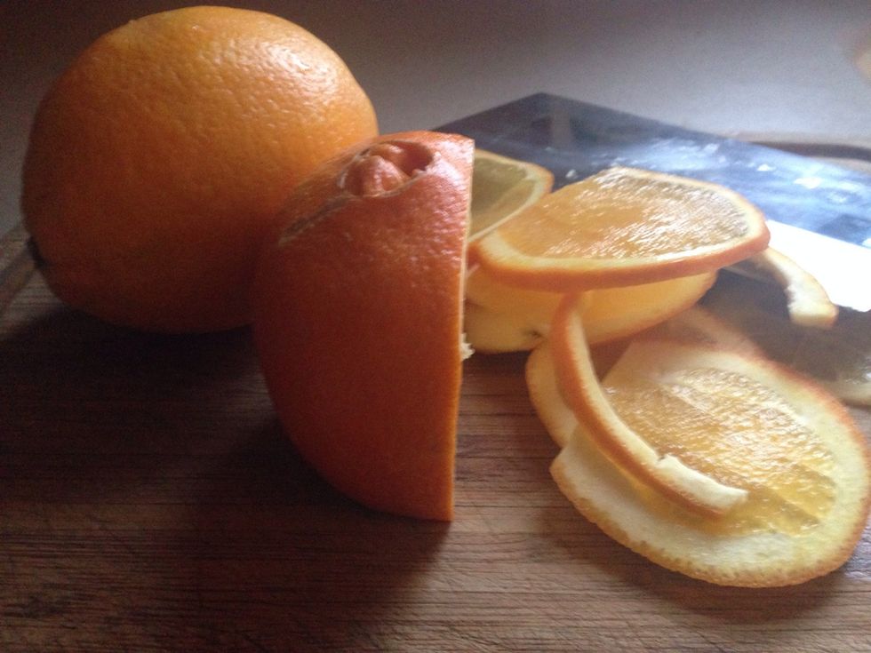 Thinly slice the oranges into half moon shapes